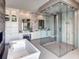 Luxurious bathroom with glass shower, soaking tub, and vanity at 3420 Channelside Ct, Safety Harbor, FL 34695