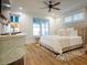 Cozy bedroom with hardwood floors, a comfortable bed, ample natural light, and stylish decor at 3420 Channelside Ct, Safety Harbor, FL 34695
