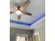Stylish tray ceiling with a fan and LED accent lighting, adding a modern touch at 3420 Channelside Ct, Safety Harbor, FL 34695