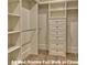 Spacious walk-in closet featuring custom shelving and ample storage space at 3420 Channelside Ct, Safety Harbor, FL 34695