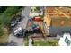 New home construction featuring a crane lifting construction materials, and adjacent new homes at 3420 Channelside Ct, Safety Harbor, FL 34695