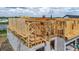 New construction home frame showing construction details and adjacent water view homesite at 3420 Channelside Ct, Safety Harbor, FL 34695