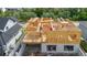 Home under construction showcasing the wooden framing, foundation, and initial structure in a residential neighborhood at 3420 Channelside Ct, Safety Harbor, FL 34695