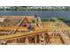 Home under construction with wooden framing; construction workers visible, with a waterfront view in the background at 3420 Channelside Ct, Safety Harbor, FL 34695