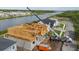 Construction of new home with water view and neighboring properties along the street at 3420 Channelside Ct, Safety Harbor, FL 34695
