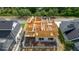 Aerial view of a new home framing and adjacent homes in a waterfront community at 3420 Channelside Ct, Safety Harbor, FL 34695