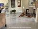 Bright dining room featuring a modern table set, art pieces and 24 X 36 porcelain floor tiles at 3420 Channelside Ct, Safety Harbor, FL 34695
