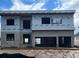 Modern home under construction, featuring a block foundation and Typar weather barrier at 3420 Channelside Ct, Safety Harbor, FL 34695