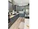 Modern kitchen with stainless steel appliances, ample cabinet space, and wood-look flooring at 3420 Channelside Ct, Safety Harbor, FL 34695