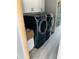 Convenient laundry room with front-load washer and dryer, plus overhead cabinets at 3420 Channelside Ct, Safety Harbor, FL 34695