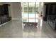 Bright living room with modern tile floors, stylish furniture, and large windows overlooking the pool area at 3420 Channelside Ct, Safety Harbor, FL 34695