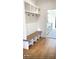 Charming mudroom with a bench, cubbies, hooks, and adjacent door to the kitchen at 3420 Channelside Ct, Safety Harbor, FL 34695