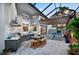 Inviting outdoor kitchen with stainless steel grill, sink, dining area, and covered seating at 3420 Channelside Ct, Safety Harbor, FL 34695