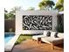 Backyard oasis with pool, lounge chairs, and artistic wall decoration at 3420 Channelside Ct, Safety Harbor, FL 34695