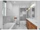 Elegant bathroom featuring marble accents, a modern bathtub, and a double vanity at 349 Belleair Ne Dr, St Petersburg, FL 33704