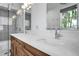 Elegant bathroom featuring a double vanity, walk-in shower, and stylish lighting at 349 Belleair Ne Dr, St Petersburg, FL 33704