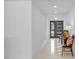 Bright and airy entryway features neutral walls, modern sconces, tile floor, and stylish front door at 349 Belleair Ne Dr, St Petersburg, FL 33704