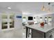 Kitchen island featuring a white countertop and views into an adjacent sitting area with TV at 349 Belleair Ne Dr, St Petersburg, FL 33704