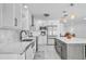 Modern kitchen featuring stainless steel appliances, bright white cabinetry, and a center island at 349 Belleair Ne Dr, St Petersburg, FL 33704