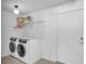 Bright laundry room featuring a modern washer and dryer, and plenty of storage at 349 Belleair Ne Dr, St Petersburg, FL 33704