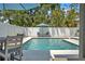 Backyard with a private pool surrounded by a white fence and lush tropical landscaping for a tranquil oasis at 349 Belleair Ne Dr, St Petersburg, FL 33704