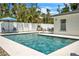 Beautiful pool featuring stylish lounge chairs, clear blue water, and lush green landscaping at 349 Belleair Ne Dr, St Petersburg, FL 33704