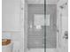 Modern shower featuring gray subway tiles, a sleek glass enclosure, and marble accents at 349 Belleair Ne Dr, St Petersburg, FL 33704