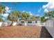 Wide view of the home's backyard featuring new mulch and a white privacy fence at 3512 Haines N Rd, St Petersburg, FL 33704