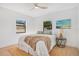 Serene bedroom showcasing a comfy bed, modern ceiling fan, and a window providing natural light and a view at 3512 Haines N Rd, St Petersburg, FL 33704