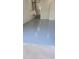 Spacious garage with a newly painted floor and stairs to a bright doorway at 3512 Haines N Rd, St Petersburg, FL 33704