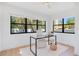 Home office featuring a sleek desk, modern decor, and a large window providing ample natural light and a refreshing view at 3512 Haines N Rd, St Petersburg, FL 33704