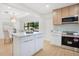 Modern kitchen featuring stainless steel appliances, two-tone cabinets, a kitchen island and a dining area at 3512 Haines N Rd, St Petersburg, FL 33704