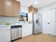 Modern kitchen showcasing stainless steel appliances, wooden cabinets, white counters and a sleek design at 3512 Haines N Rd, St Petersburg, FL 33704