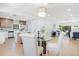 Open-concept living room and kitchen area with modern decor and plenty of natural light from the windows at 3512 Haines N Rd, St Petersburg, FL 33704