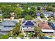 Aerial view of neighborhood home with solar panels, landscaped yard, and swimming pool at 3710 W San Pedro St, Tampa, FL 33629