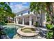 Lush backyard featuring a pool, jacuzzi, covered patio, and play structure at 3710 W San Pedro St, Tampa, FL 33629