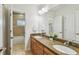 Bright bathroom featuring granite counters, double sinks, and tiled shower with a neutral color palette at 3710 W San Pedro St, Tampa, FL 33629