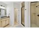 Bathroom features tiled walk-in shower, vanity with granite countertop, mirror and tiled floors at 3710 W San Pedro St, Tampa, FL 33629