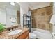 Well-lit bathroom with a granite vanity, tiled shower, and modern fixtures at 3710 W San Pedro St, Tampa, FL 33629