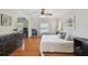 Bright primary bedroom featuring wood floors, ceiling fan, and a large window at 3710 W San Pedro St, Tampa, FL 33629