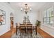 Dining room with a chandelier, hardwood floors, natural light, and a view of the kitchen at 3710 W San Pedro St, Tampa, FL 33629