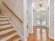 Bright foyer with wood staircase, hardwood floors, and arched entryway at 3710 W San Pedro St, Tampa, FL 33629