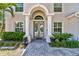 Close-up of front entrance with double doors, columns, an arched transom, and a paved walkway at 3710 W San Pedro St, Tampa, FL 33629