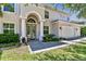 Inviting home exterior highlighting the arched entryway, manicured landscaping, and attached three-car garage at 3710 W San Pedro St, Tampa, FL 33629