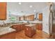 Spacious kitchen featuring wooden cabinets, granite countertops, stainless steel appliances, and a center island at 3710 W San Pedro St, Tampa, FL 33629