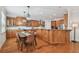 Open kitchen featuring wood cabinets, granite countertops, stainless appliances, and eat-in dining area at 3710 W San Pedro St, Tampa, FL 33629