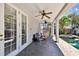 Covered patio with ceiling fans, comfortable seating, and views of the landscaped pool and jacuzzi at 3710 W San Pedro St, Tampa, FL 33629