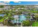 Aerial view of community pool with palm trees, lake views, and residential surroundings at 3716 Forest Path Dr, Plant City, FL 33565