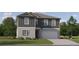 Charming two-story home featuring a gray color scheme, manicured lawn, and attached two car garage at 3716 Forest Path Dr, Plant City, FL 33565