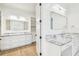Bright bathroom with dual sinks, marble countertops, and access to a well-organized walk-in closet at 3821 W Vasconia St, Tampa, FL 33629